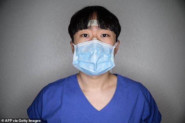 South Korea reported 110 new infections on Friday, the lowest in three weeks. Depicted, nurse Yang Uewl rock