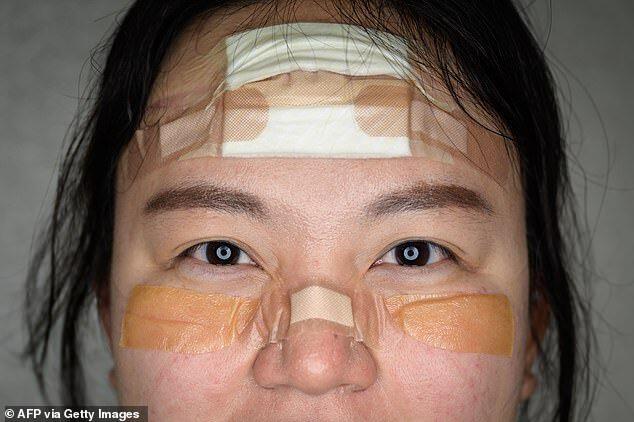 The pads, plasters and tape protect Nurse Kim Do-yeon's face from lesions while wearing her protective gear for hours