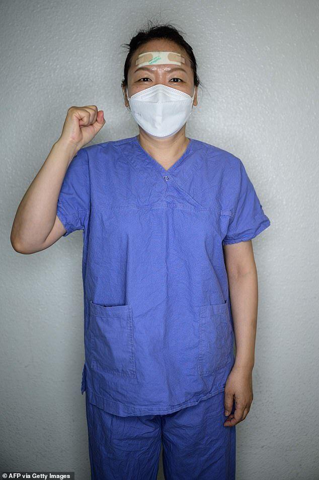Nurse Park Kyung-mi poses for a portrait of a break between services caring for patients infected with the new COVID-19 coronavirus