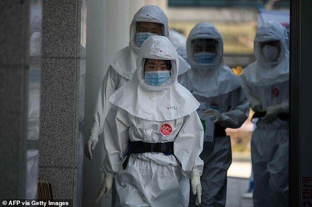 The hospital, which is one of the largest in Daegu, employs teams of full-time and volunteer nurses. Depicted, medical workers in their protective clothing