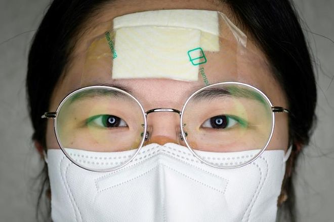 a close up of a woman wearing glasses: Teams of full-time and volunteer nurses operate at the hospital, one of the biggest in the city